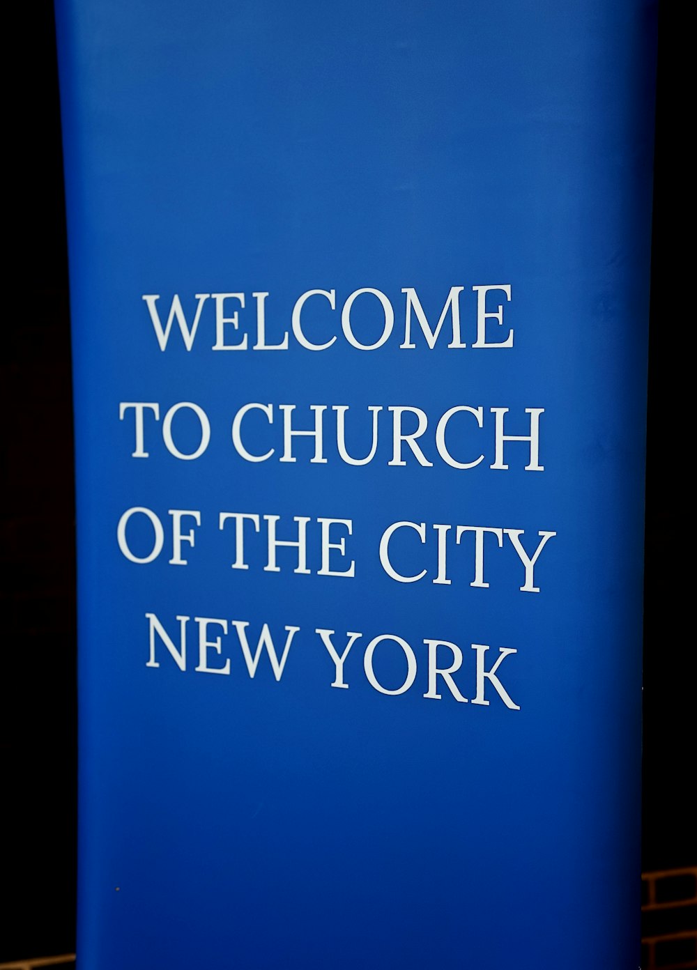 a blue sign that says welcome to church of the city of new york