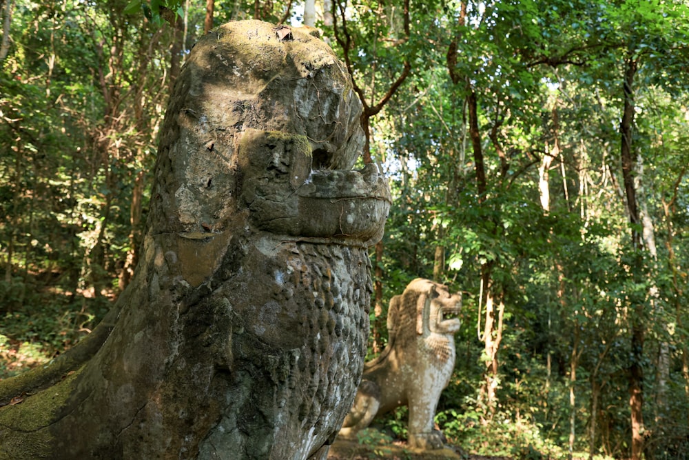 a statue in the middle of a forest