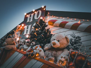 a large teddy bear sitting on top of a pile of stuffed animals
