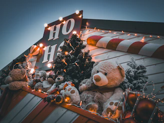 a large teddy bear sitting on top of a pile of stuffed animals