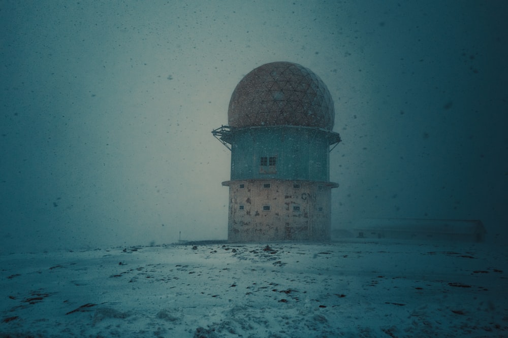 a large dome sitting on top of a snow covered field