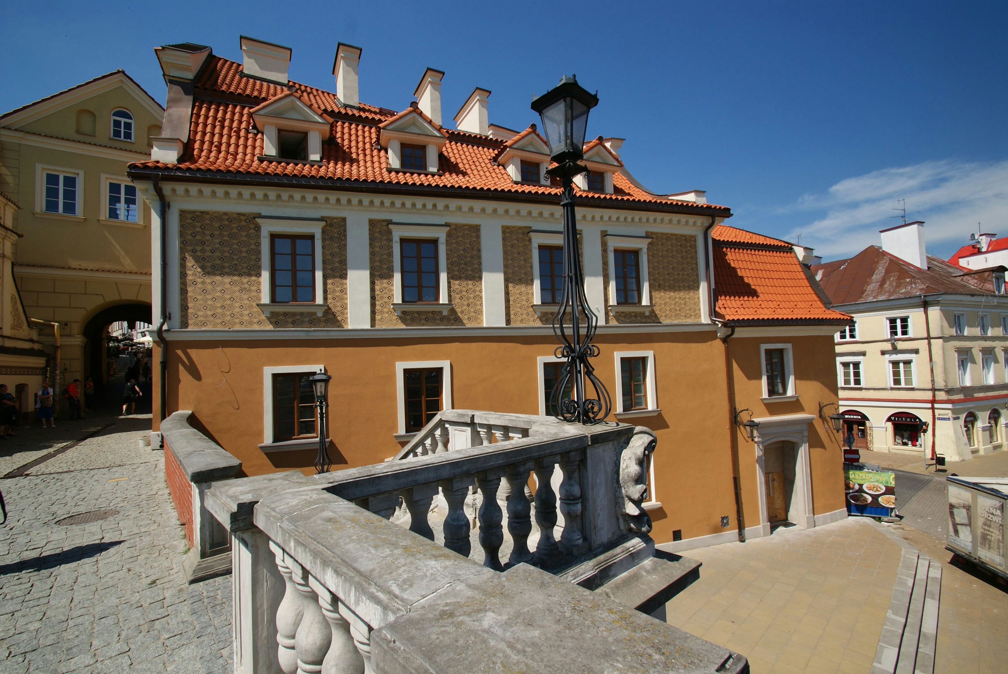 a building with a red roof and a balcony