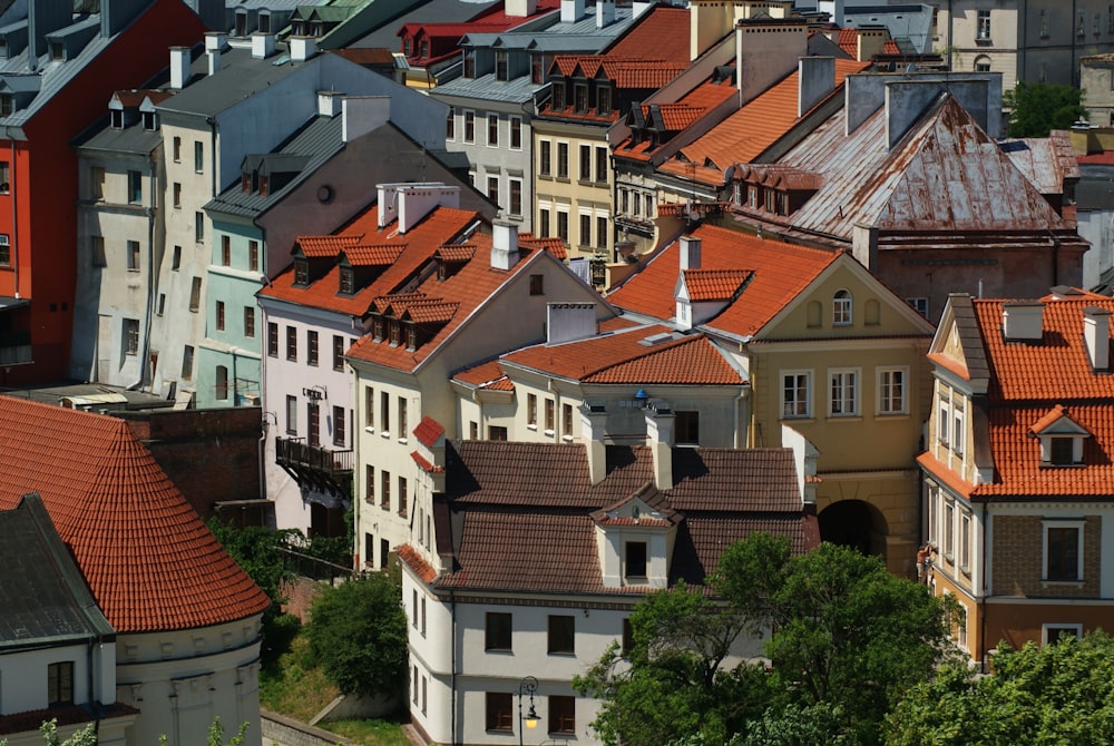 a group of buildings with red roofs in a city