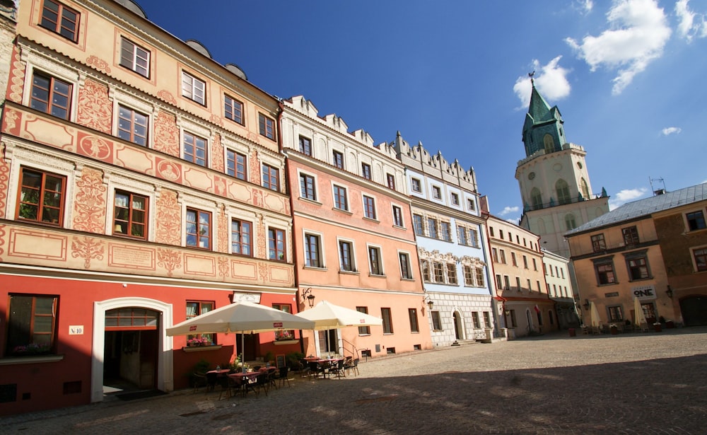 a row of buildings with a clock tower in the background
