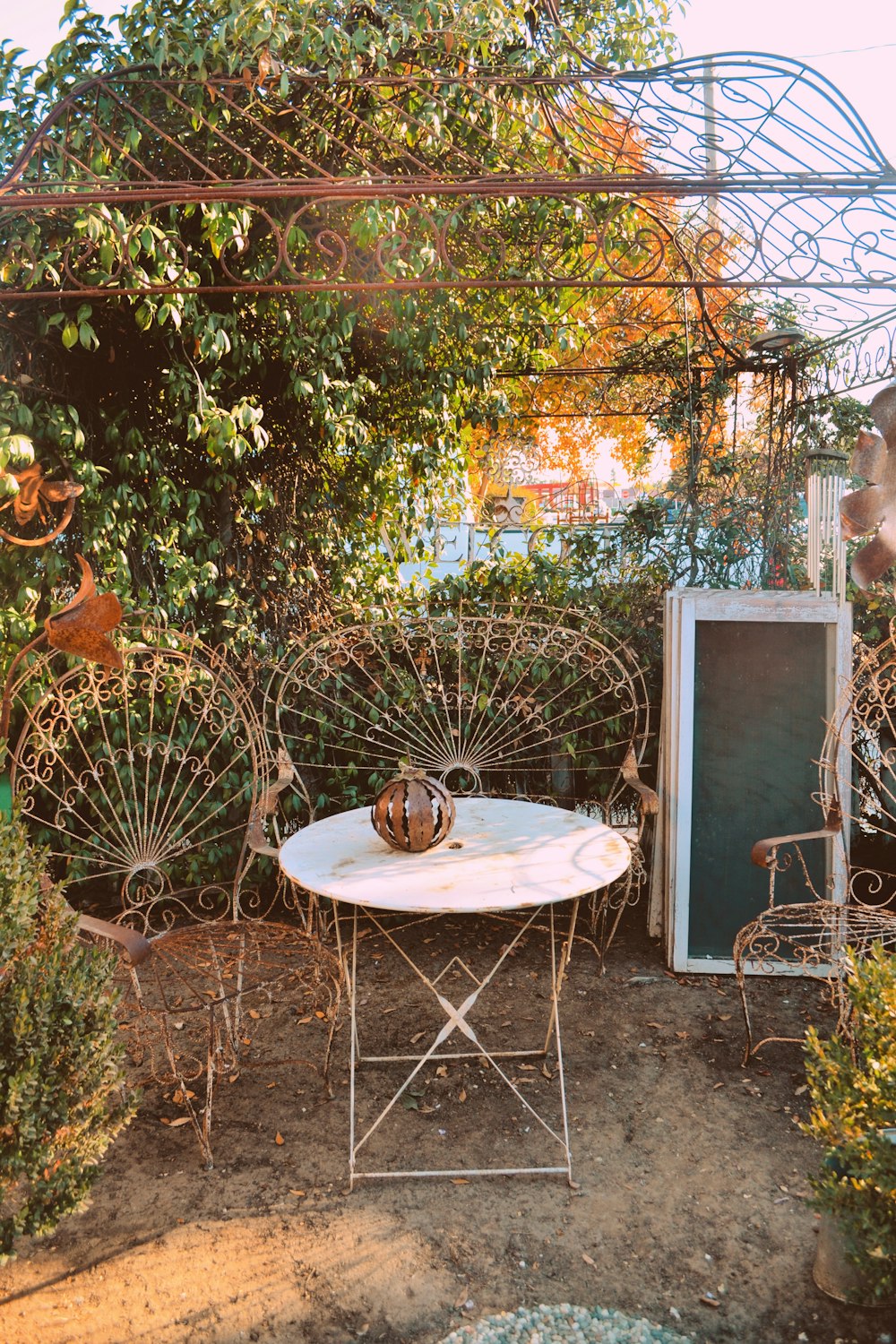 a white table and chairs in a garden