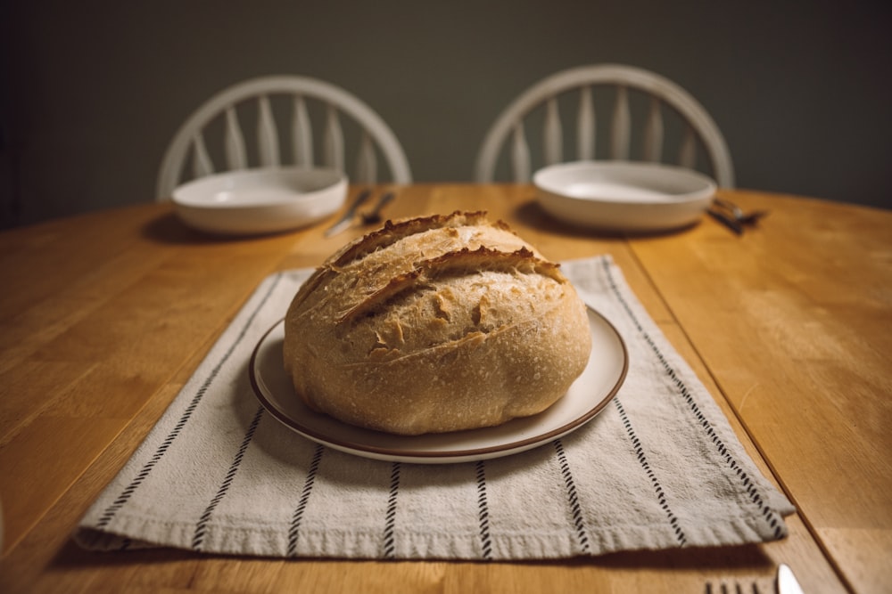 a loaf of bread sitting on top of a white plate