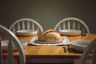 Family sharing bread around a cozy dining table