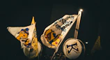 Wind banner in black and gold colors displayed at an event entrance