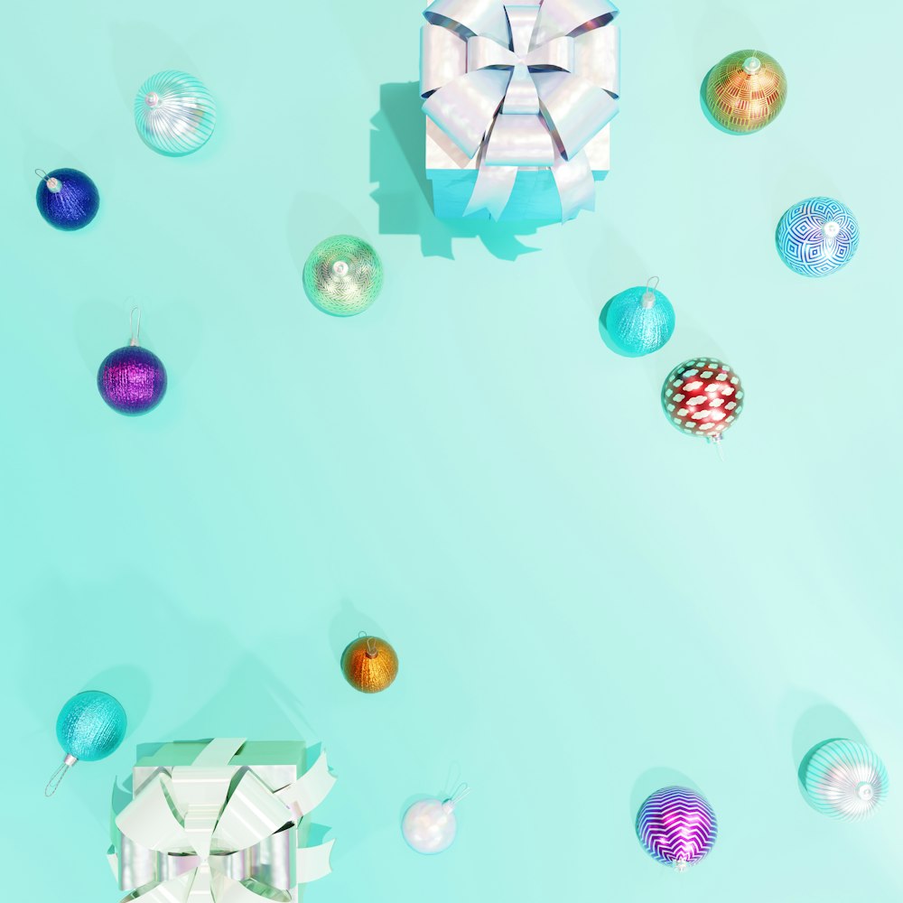 a blue background with ornaments and a gift box