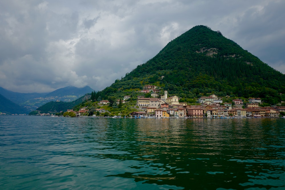 a large body of water with houses on a hill in the background