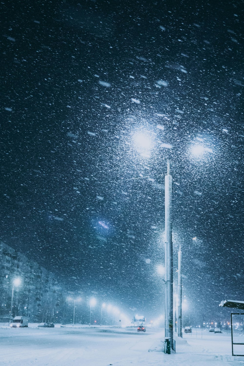 a snowy night in a city with street lights