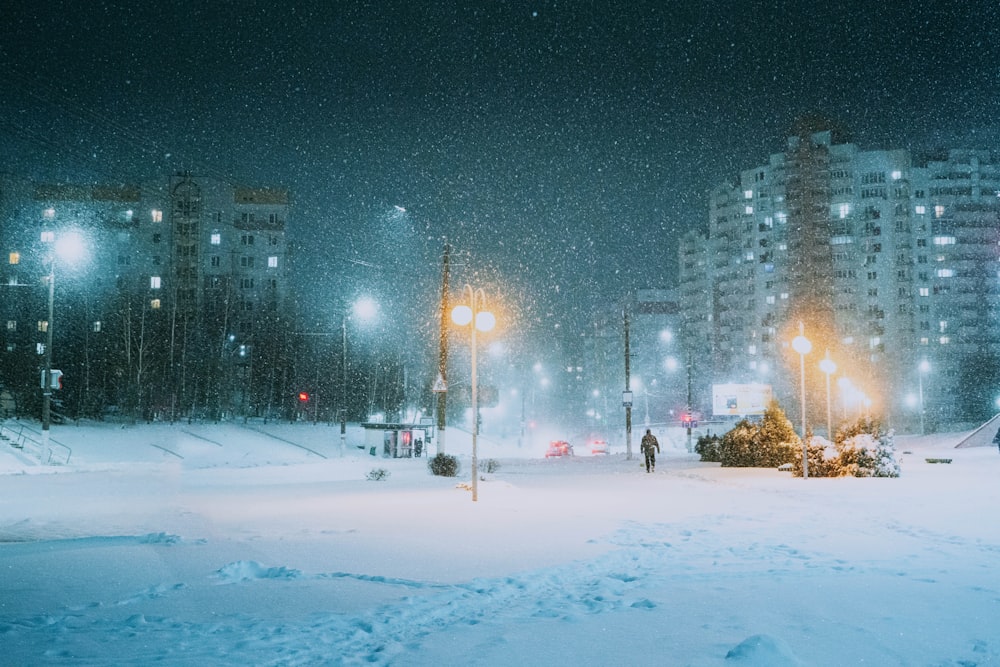 a snowy night in a big city with a lot of lights
