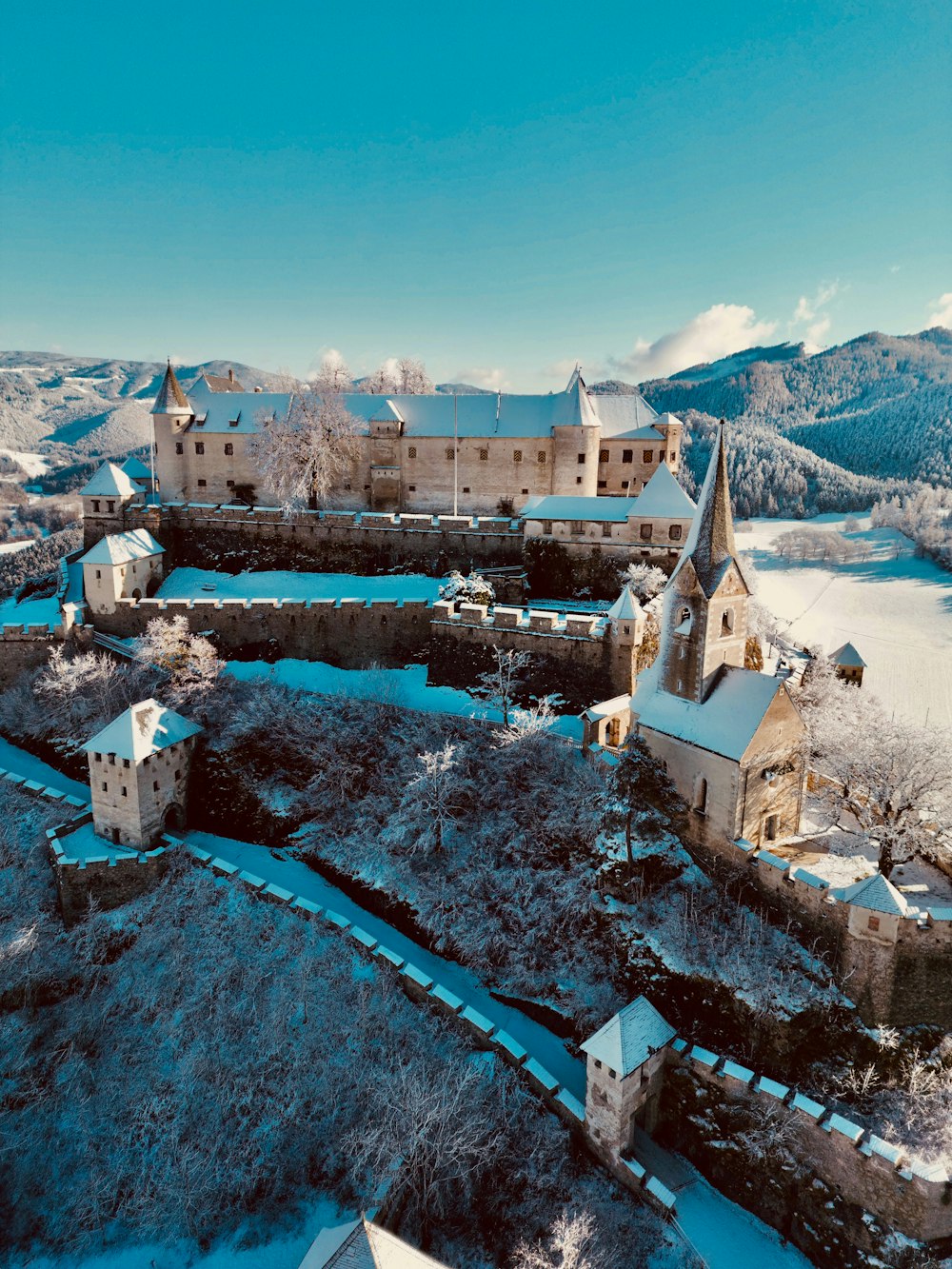 an aerial view of a castle in the snow