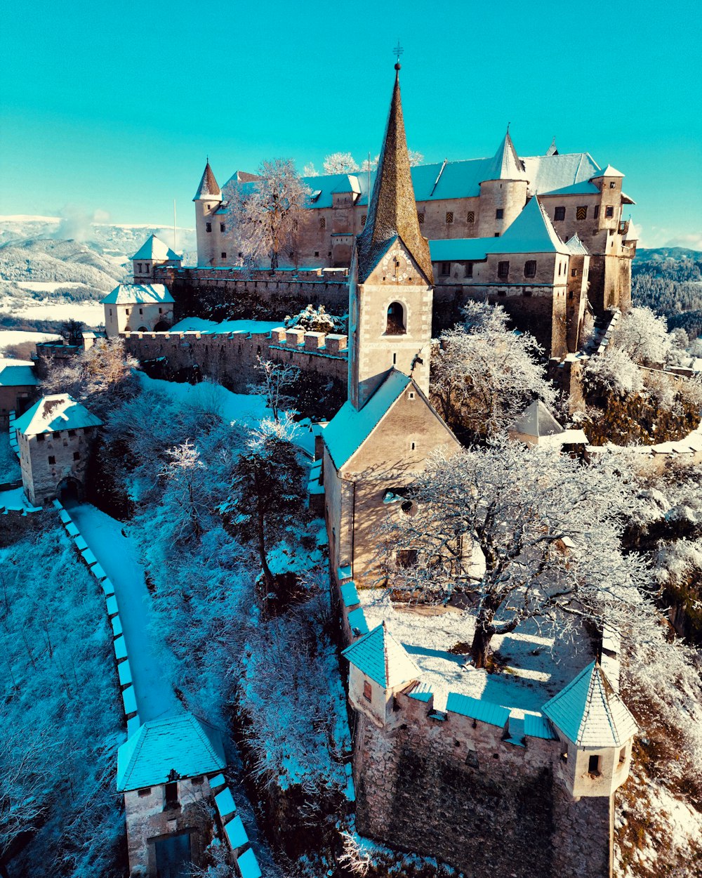 an aerial view of a castle in the snow