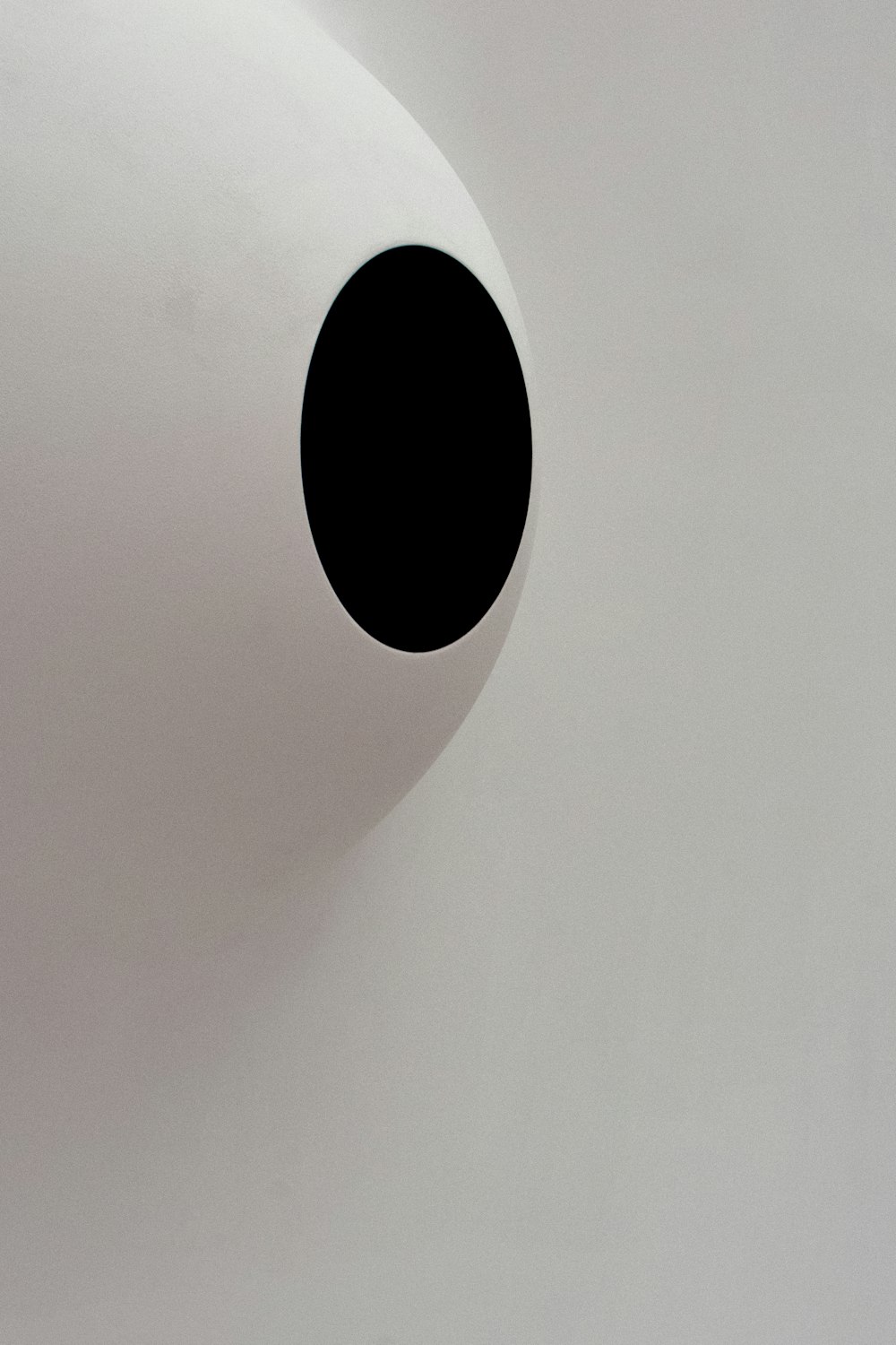 a white wall with a black hole in it