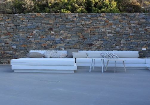 Modern outdoor seating area surrounded by natural stone walls.