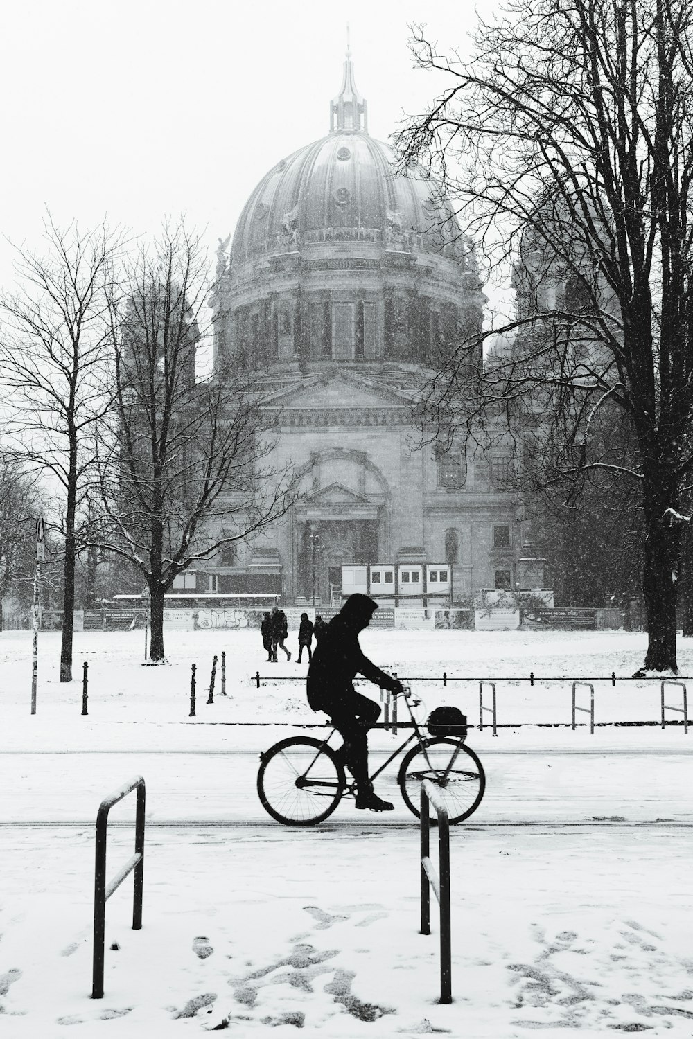 a person riding a bike in the snow