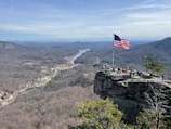 A group of veterans standing proudly in a scenic Appalachian landscape.