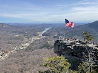 A group of diverse veterans standing together in a scenic Appalachian landscape.