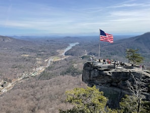 A group of veterans standing proudly in a scenic Appalachian landscape.