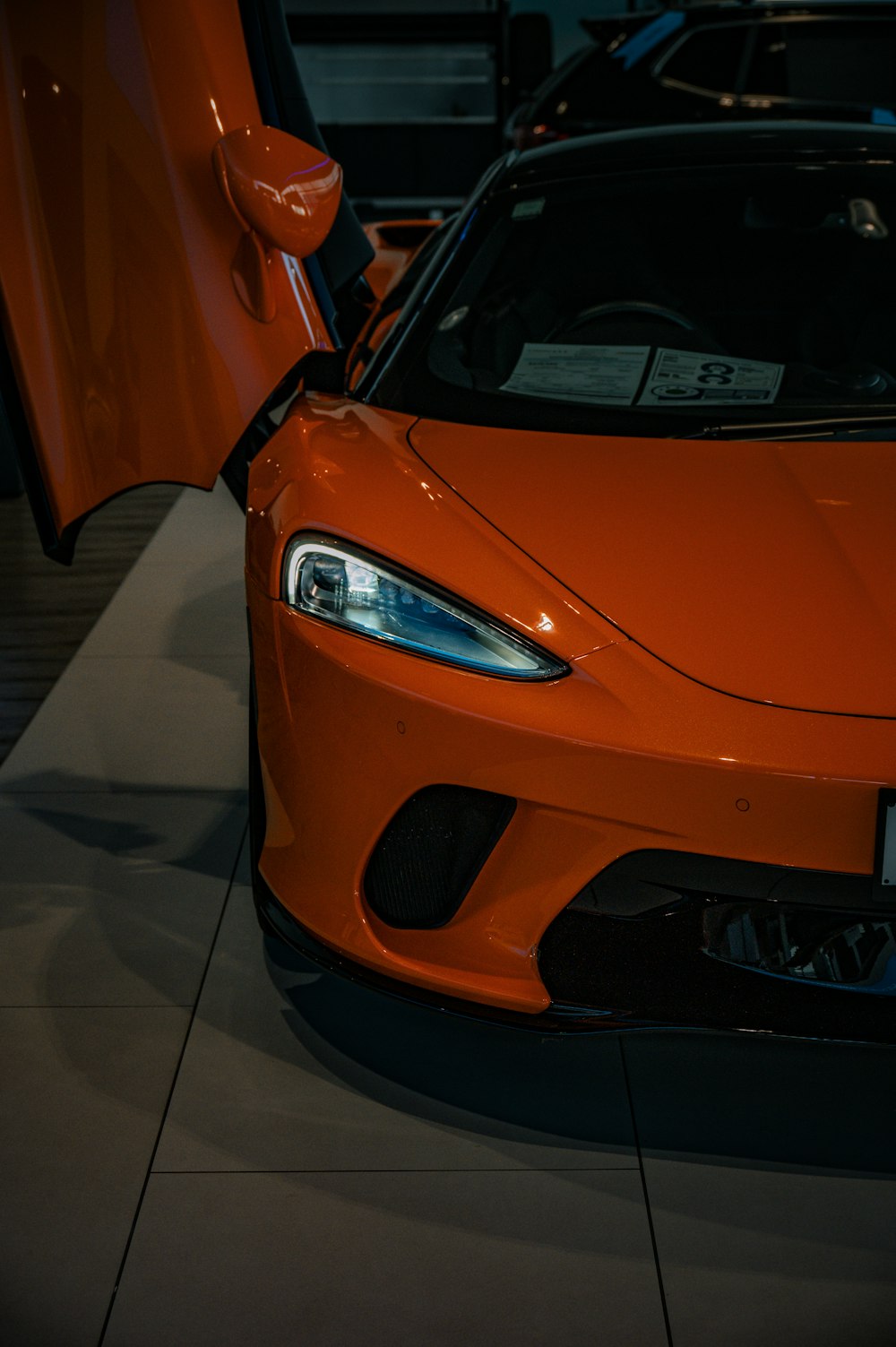 an orange sports car parked in a garage