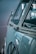 A vintage car with a focus on its side and distinctive logo on the front, featuring a classic, chrome-accented design.