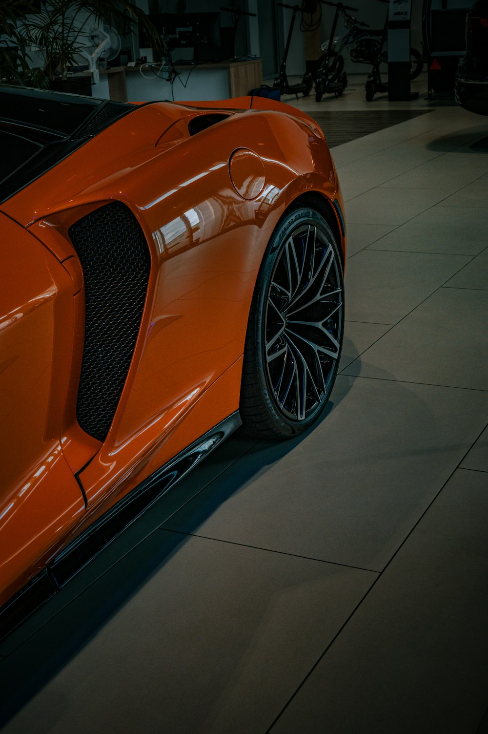 an orange sports car parked in a garage