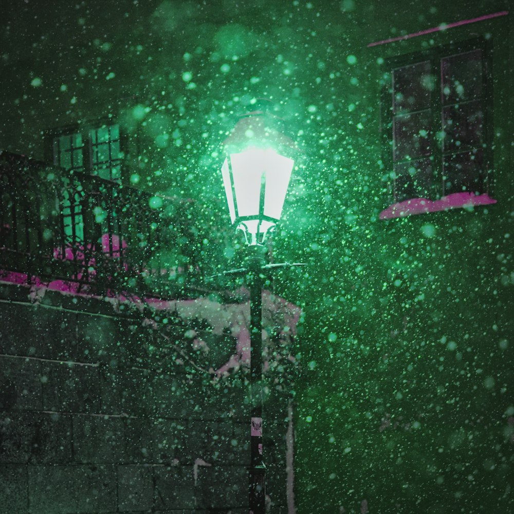 a street light in the snow at night
