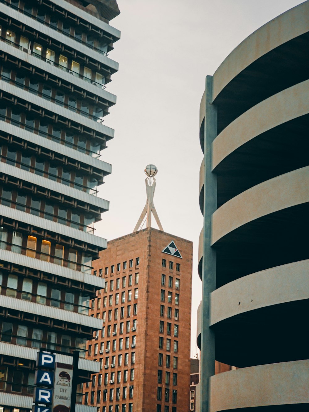 a tall building with a statue on top of it