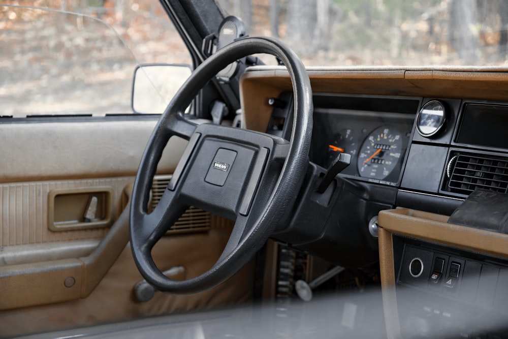 a dashboard of a car with a steering wheel