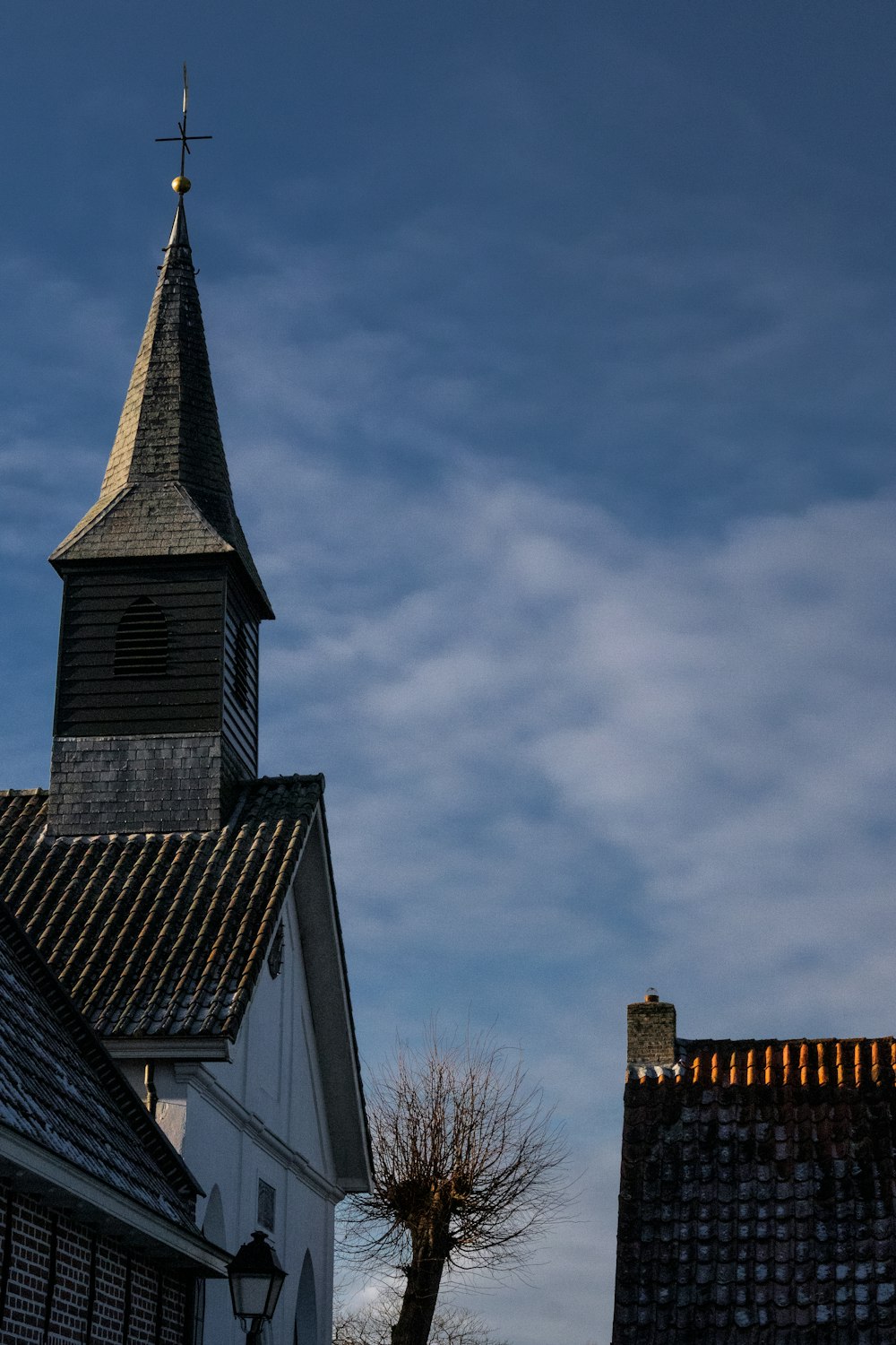 a church steeple with a cross on top of it