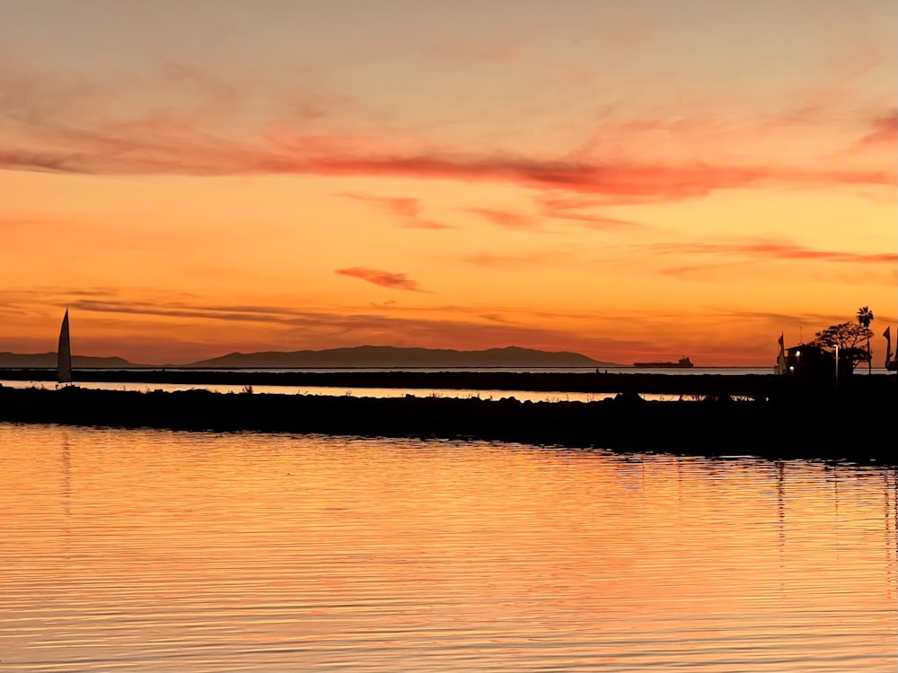 a large body of water with a boat in the distance