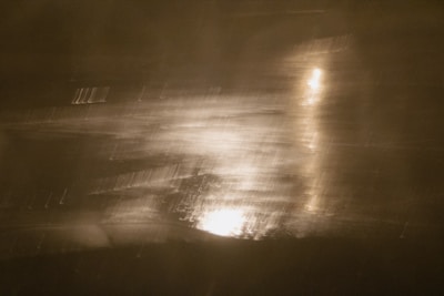 Abstract DNA linework glowing softly against a dark, textured surface.