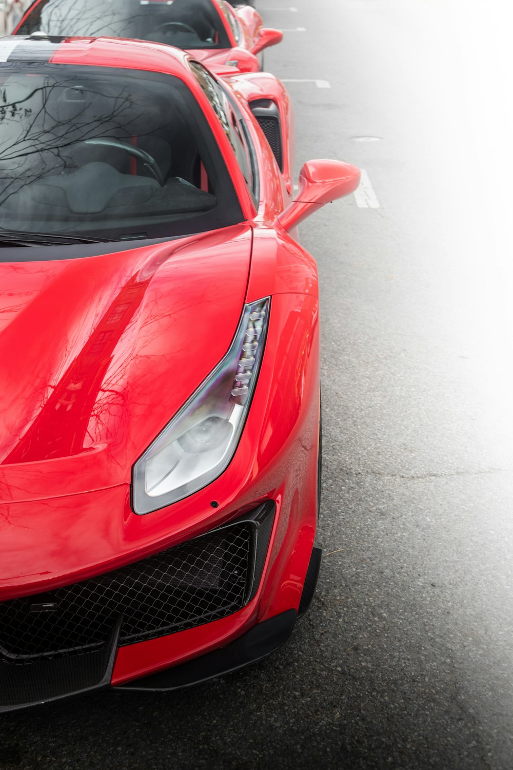 a row of red sports cars parked next to each other