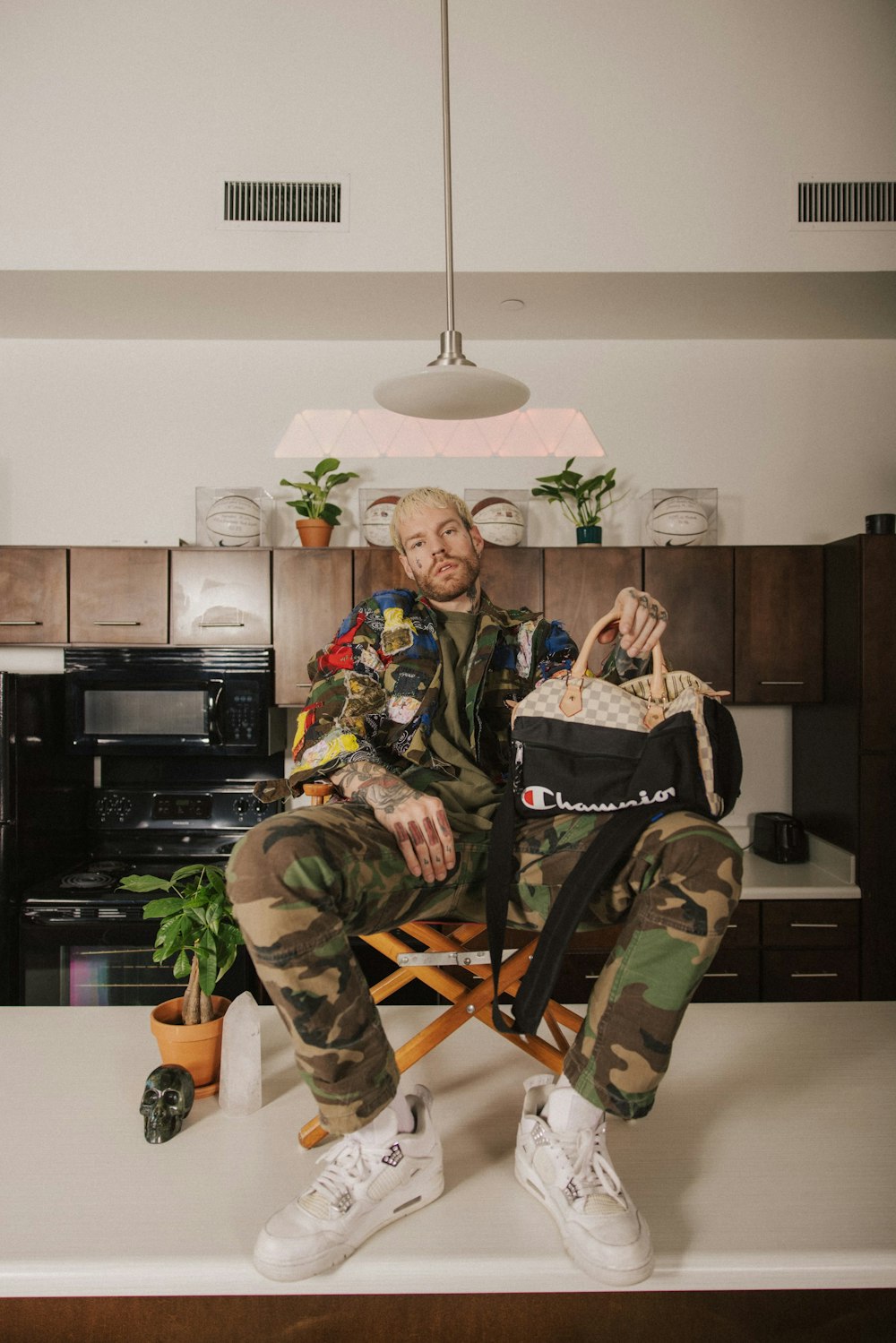 a man sitting in a chair holding a bag