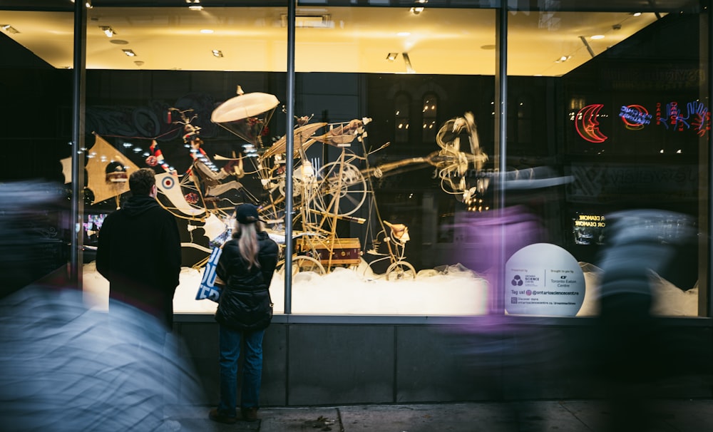 a group of people standing in front of a store window