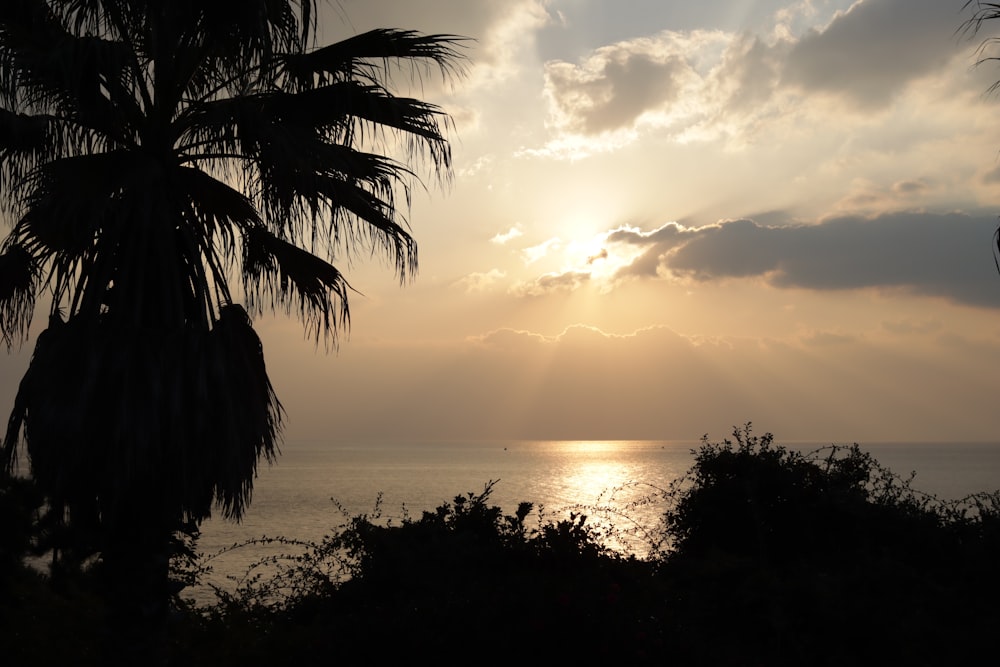 the sun is shining through the clouds over the ocean