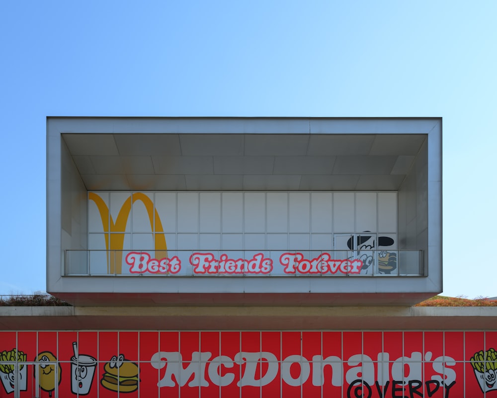 a mcdonald's restaurant with a sign above it