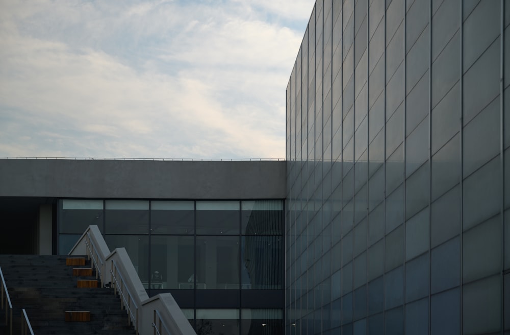 an airplane flying over a building next to a stairway