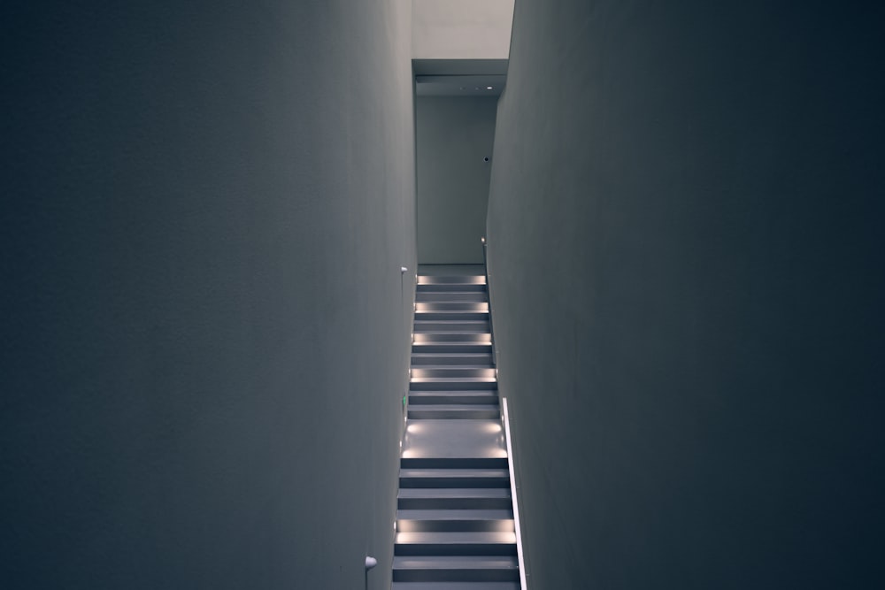 a narrow hallway with white walls and black and white striped flooring