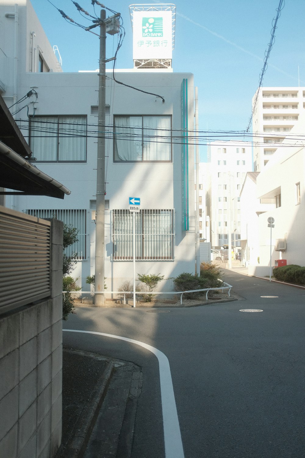an empty street with a building in the background