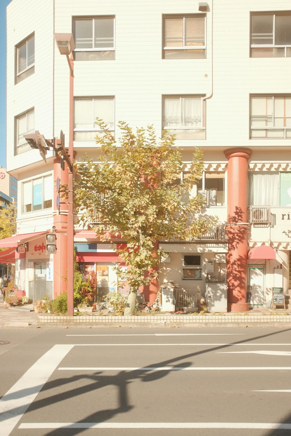 a street corner with a building and a traffic light