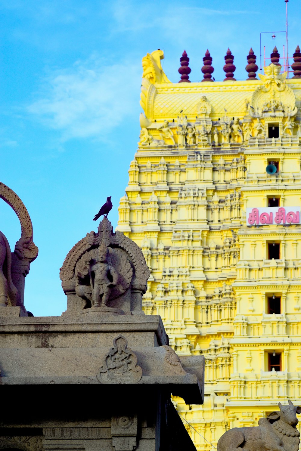 a bird is sitting on top of a statue