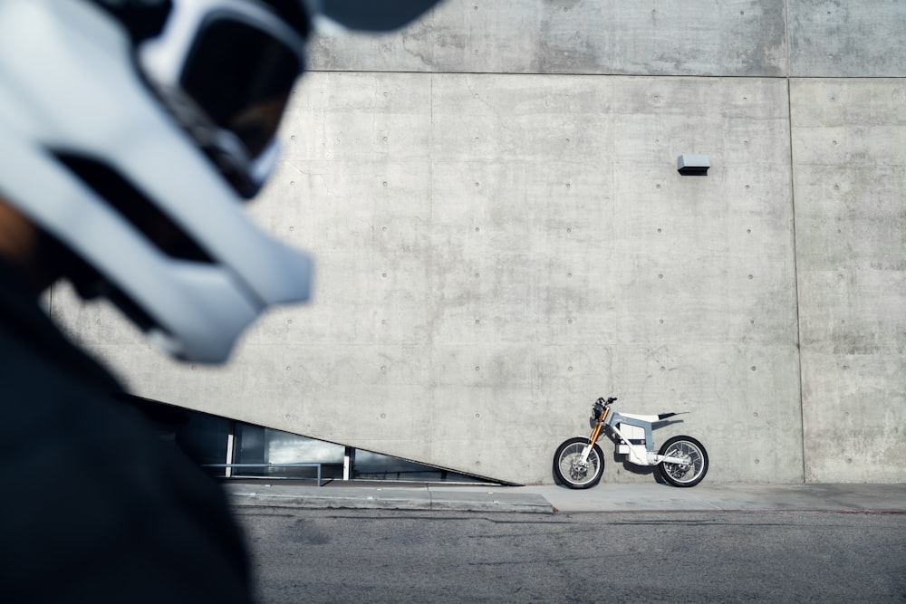 a motorcycle parked in front of a concrete wall