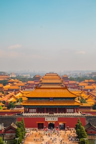 A scenic view of the Forbidden City with tourists exploring the historic site.