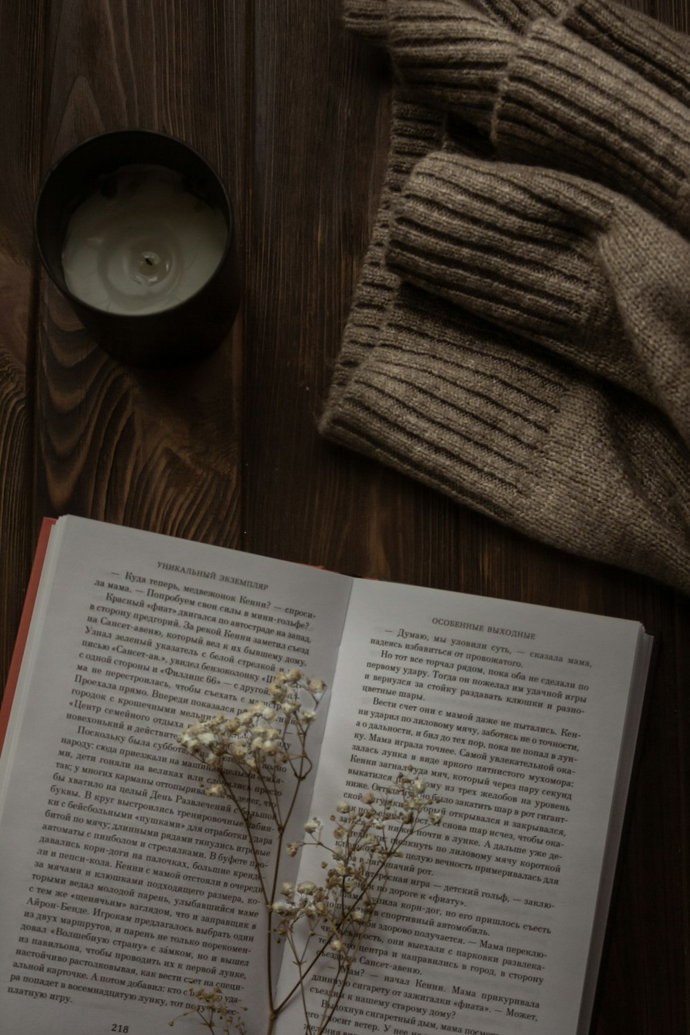 an open book with a flower on top of it