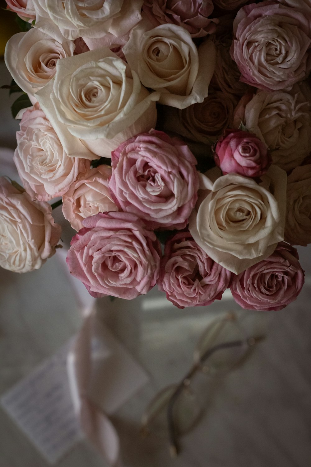 a bouquet of pink and white roses in a vase