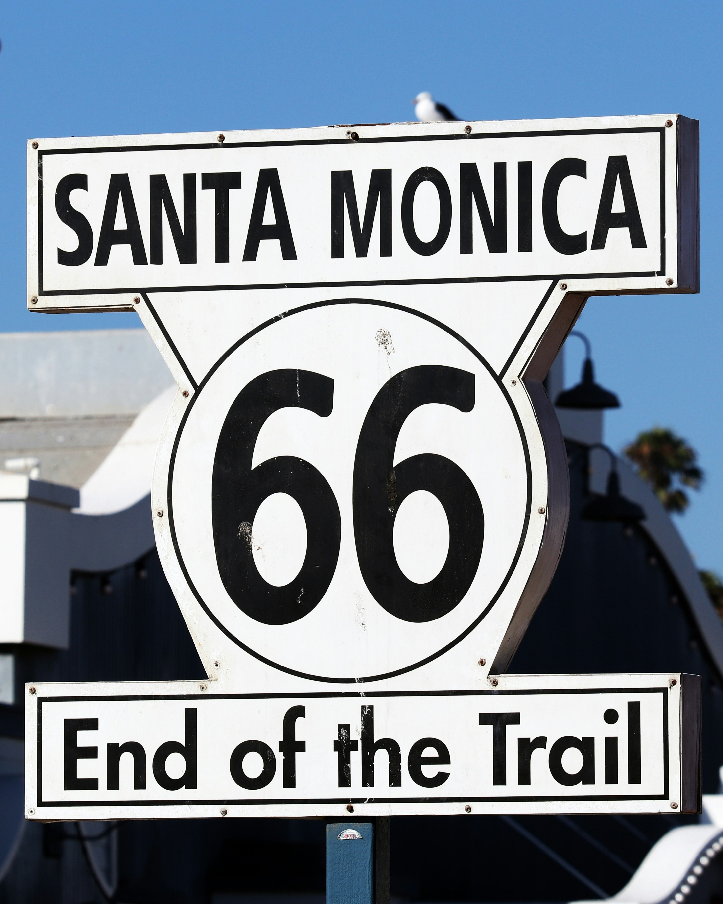 a street sign that says santa monica and the end of the trail