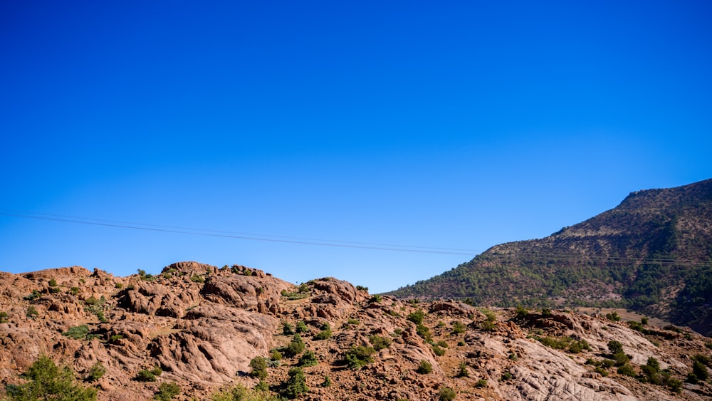 a view of a mountain with a telephone pole in the foreground