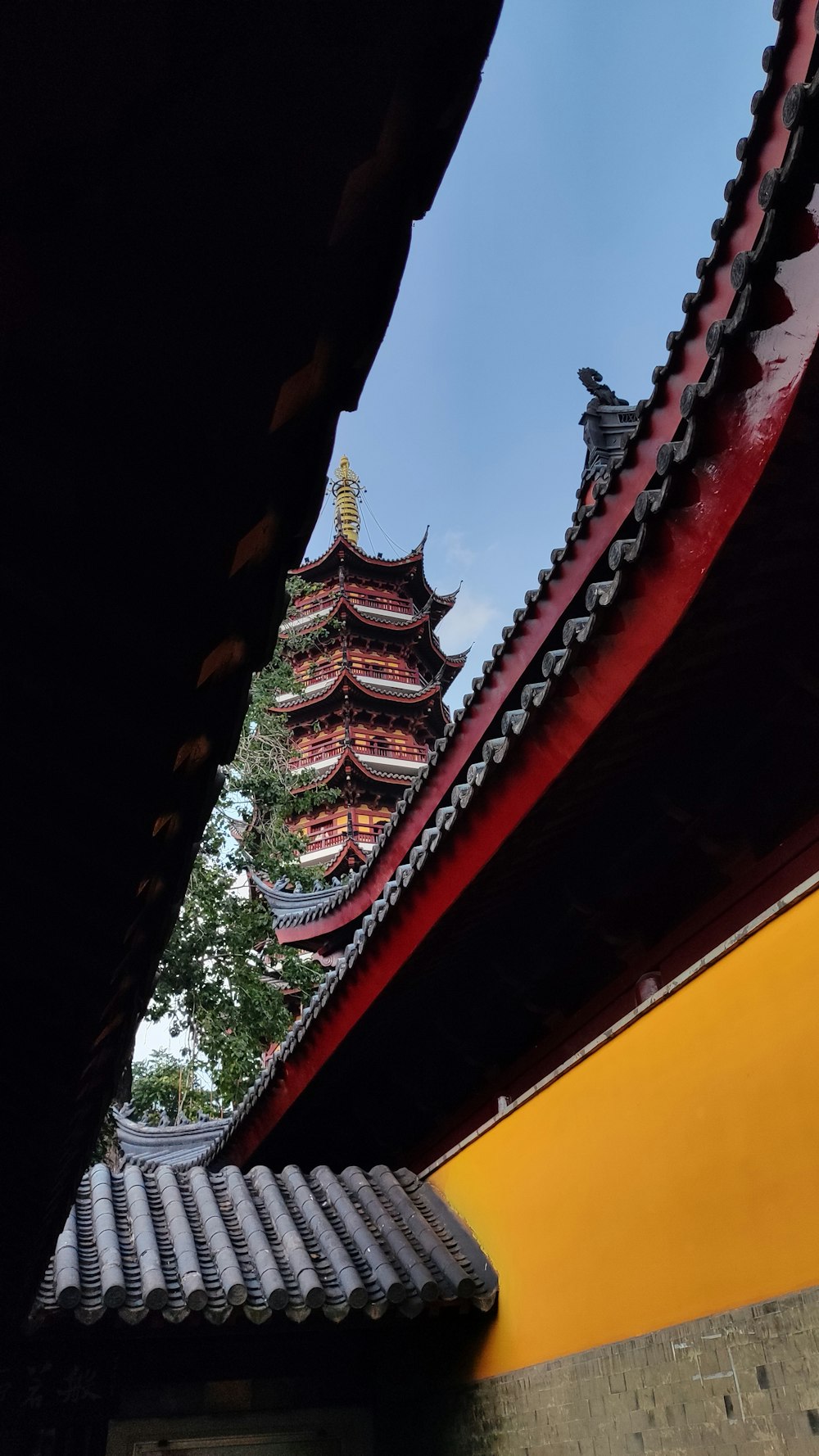 a view of a building with a tower in the background